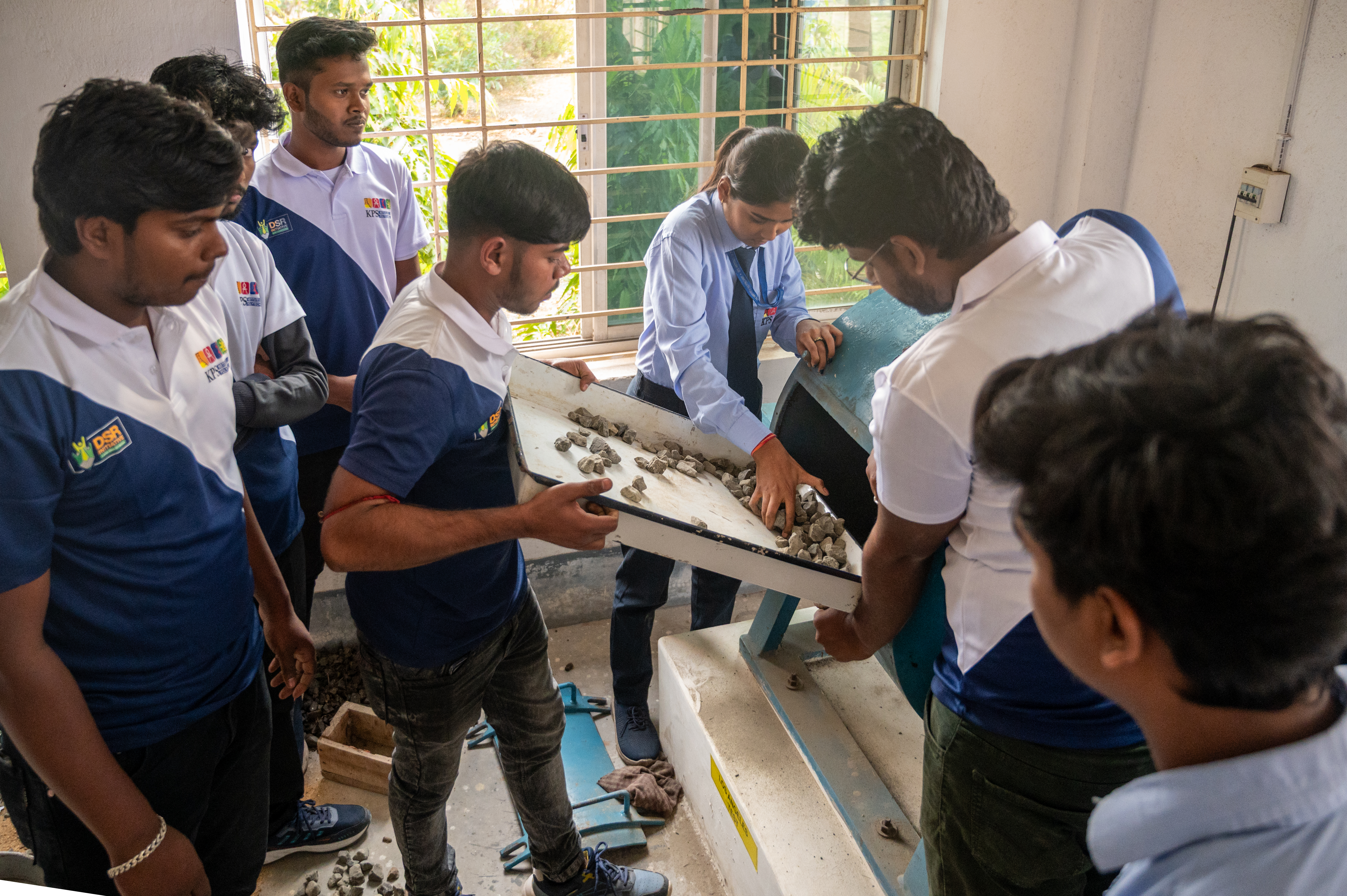 Students working with mechanical laboratory equipment