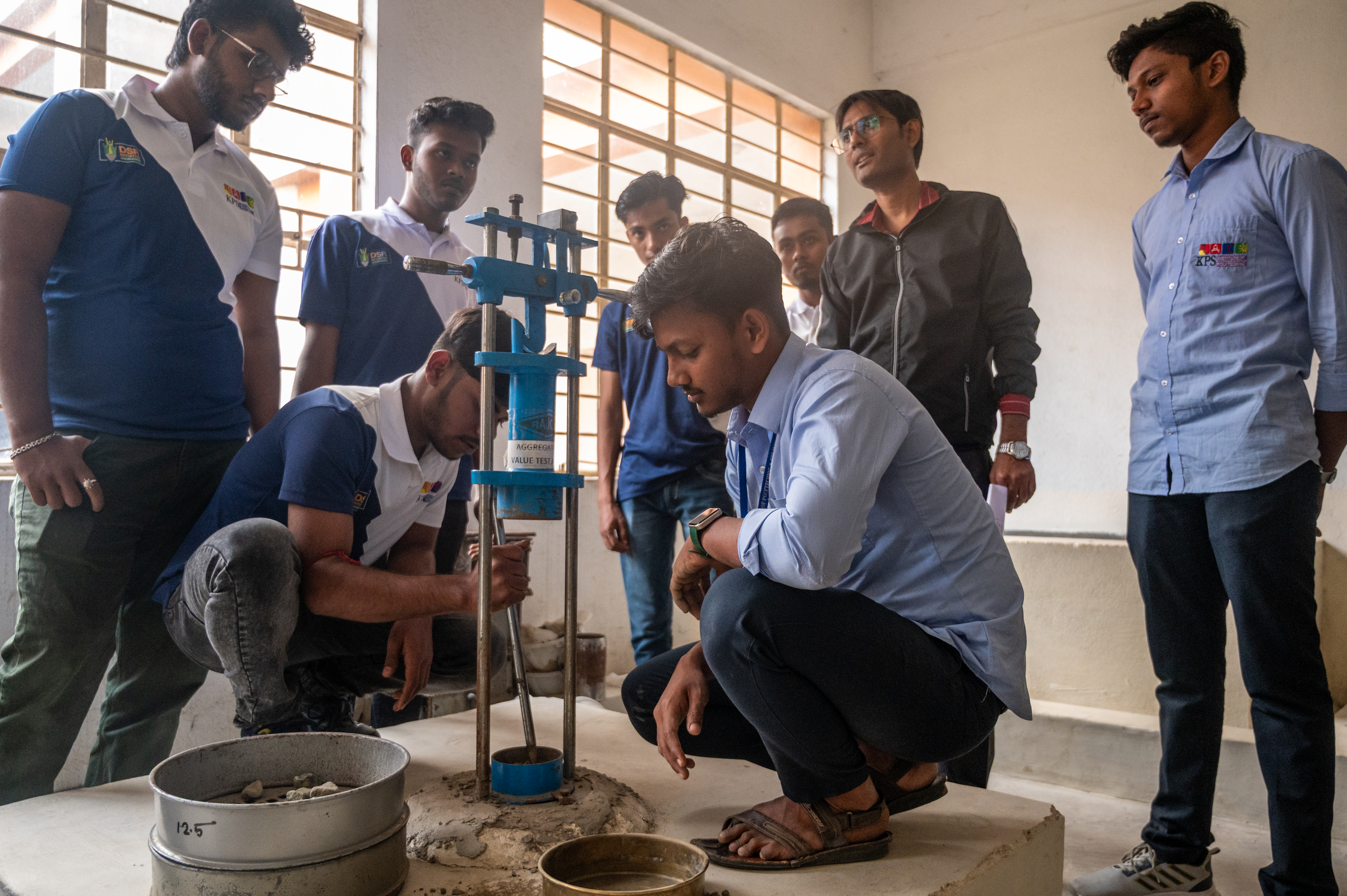Students conducting a civil engineering material test